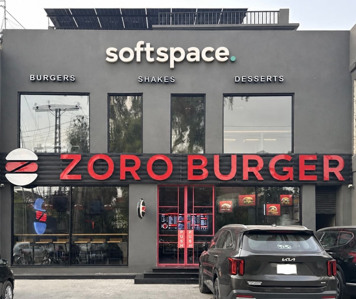 SoftSpace building exterior at Khokhar Chowk, Johar Town, with the SoftSpace sign above Zoro Burger on the ground floor